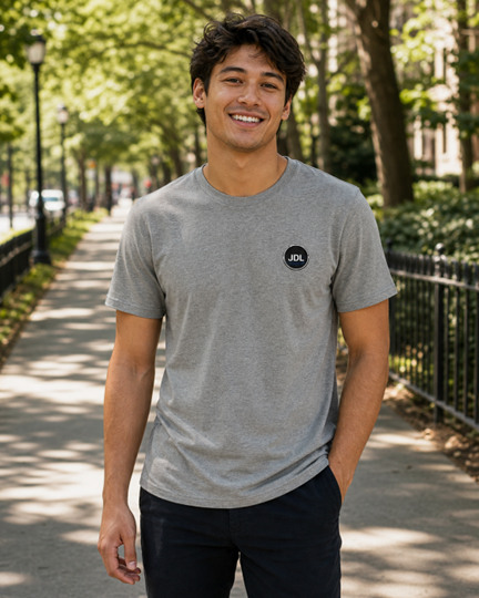 Model wearing the JDL Earth Friend Tee from the front, showing the small JDL circle chest mark.
